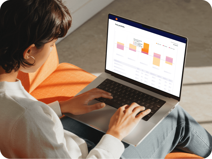 Woman working on MacBook with Sharesight on the screen.